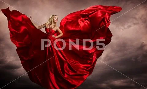 Woman Red Dress Wings, Fashion Model Silk Waving Gown, Flying in Storm Stock Photos