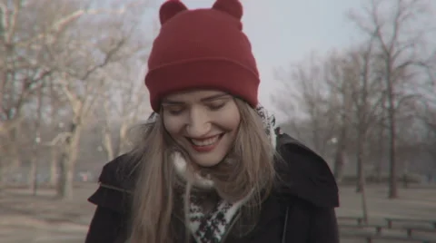 Woman in red hat looking at camera and smiling, outdoors. 動画素材 57926723
