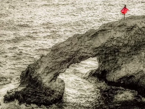 A woman in red at the top of the cliff Stock Footage