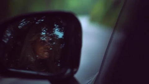 Woman reflecting in wing mirror while driving a car Stock Footage 81543525