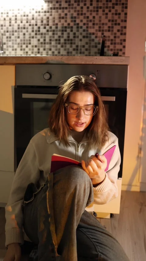 Woman refocuses and writes notes studying Stock-Footage 334056649
