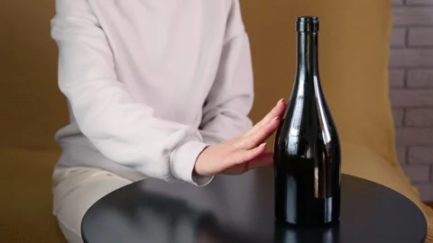 Woman refusing a bottle of wine Stock Footage 334578947