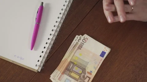 Woman refusing cash bribe by pushing euro banknote away on desk Stock Footage 333903828