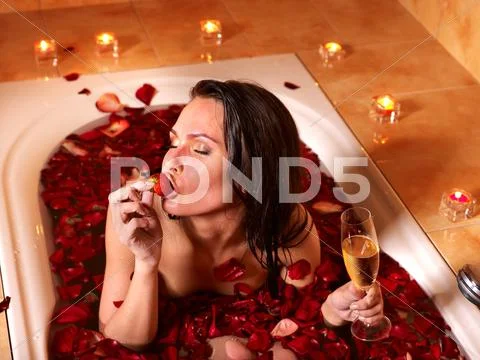 Woman relaxing in bath. Stock Photos
