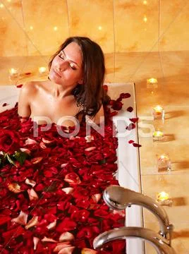 Woman relaxing in bath. Stock Photos