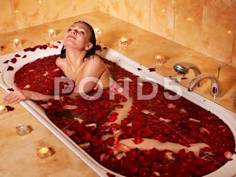 Woman relaxing in bath. Stock Photos
