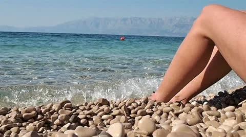 Woman relaxing on the beach Stock Footage
