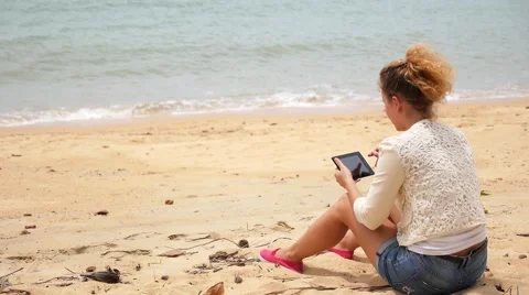 Woman Relaxing on Beach with Tablet Computer. Stock Footage 40671237