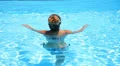 Woman Relaxing in Blue Swimming Pool in Luxury Villa. HD Footage