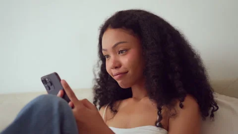 Woman Relaxing on Couch Using Smartphone. 스톡 동영상 275571663