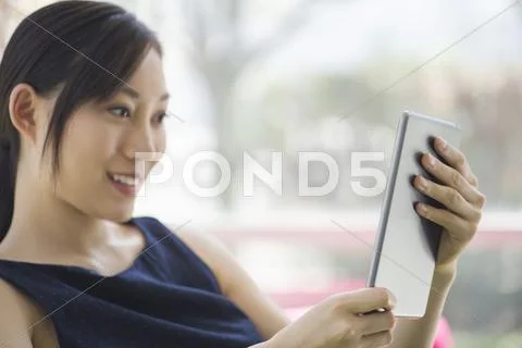 Woman Relaxing With Digital Tablet