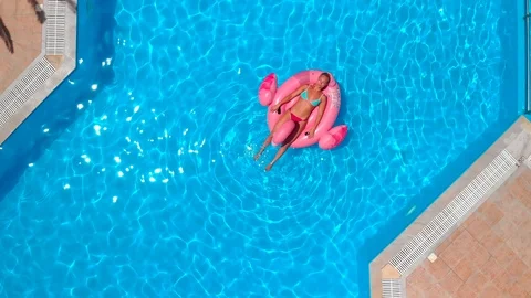 Woman relaxing on the float in the pool Stock Footage 91104568