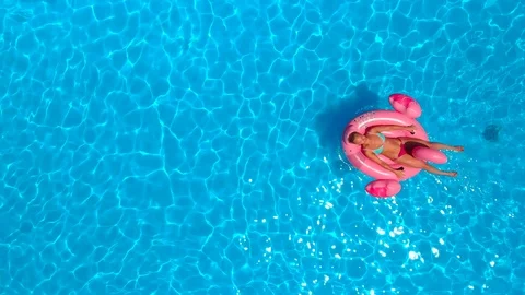 Woman relaxing on the float in the pool Stock Footage 91104571