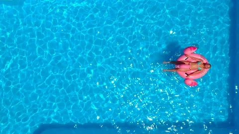 Woman relaxing on the float in the pool Stock Footage 91104603