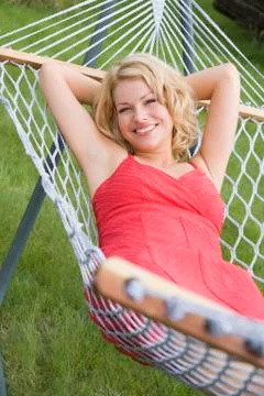 Woman relaxing in hammock smiling Stock Photos