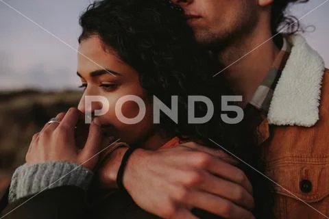 Woman relaxing in her boyfriend's arms Stock Photos