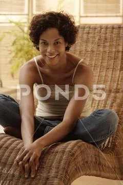 Woman relaxing at home and smiling. Stock Photos
