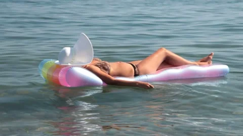 Woman relaxing on raft Stock Footage