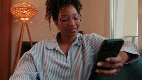 Woman Relaxing on Sofa Using Phone Stock Footage 320006115
