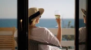 Woman Relaxing In Solitude. She Drinking Wine And Enjoying Sea View Stock Footage
