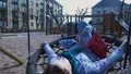 Woman relaxing in swing at city playground, childhood memories, freedom, rest HD Footage