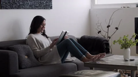Woman relaxing with tablet computer Stock Footage 53087539
