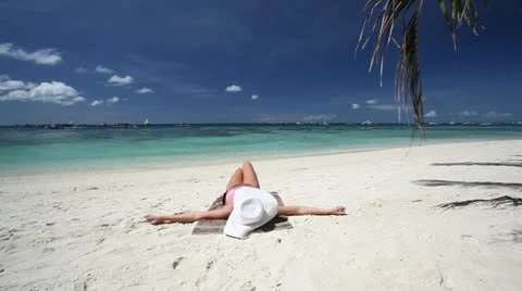 Woman relaxing on tropical beach Stock Footage
