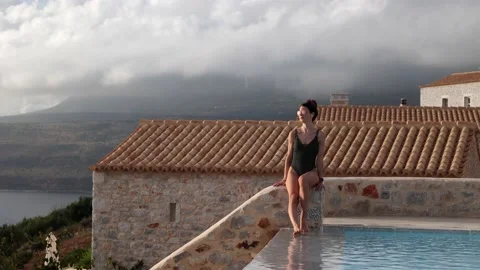 Woman relaxing while on a client call by the pool Stock Footage 199103750