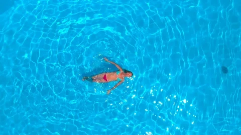 Woman relaxing while floating in the pool Stock Footage 91104643