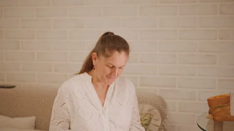 Woman reminisces while baking peacefully. Gentle woman reflects amid cozy baking Stock Footage 346392899