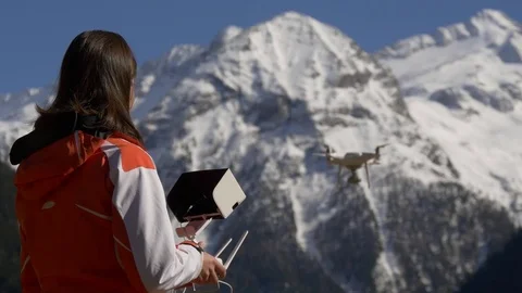 Woman with a remote control controls the drone Stock Footage 74429703
