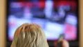 Woman with remote control switching tv channels HD Footage