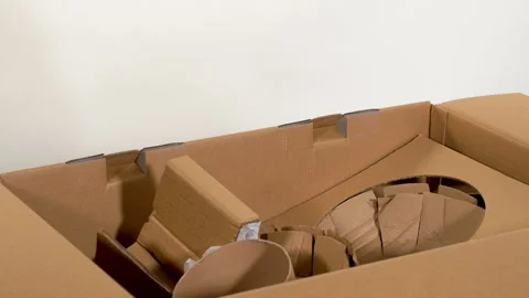Woman removing cardboard inserts from packaging 스톡 동영상 321950243