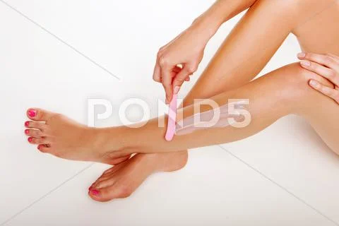Woman removing depilatory cream Stock Photos