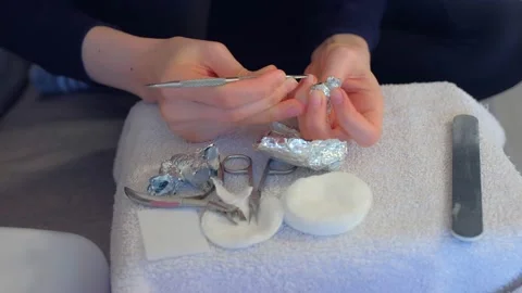 Woman removing shellac from nails using pusher and file, manicure at home. Stock Footage 136036112
