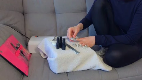 Woman removing shellac from nails using pusher, manicure at home. Video stock 137086310