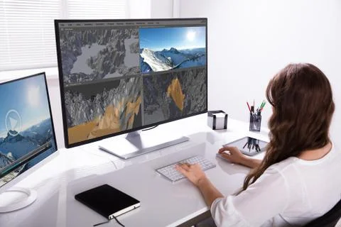 Woman Rendering 3D Landscape On Computer 写真素材