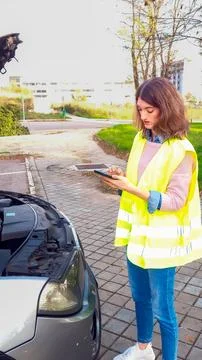Woman requesting help for broken down vehicle by cell phone Stock Photos