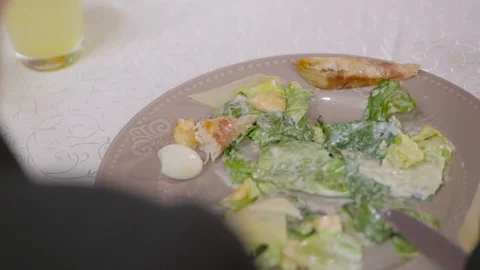 Woman in restaurant eats caesar salad. View from behind Stock Footage 98521855