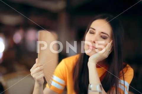 Woman in a Restaurant Fighting Heat Waves with a Fan Stock Photos