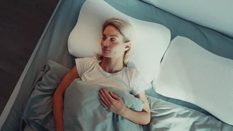 Woman Resting Calmly on Bed with Memory Foam Pillow Stock Footage 318411401