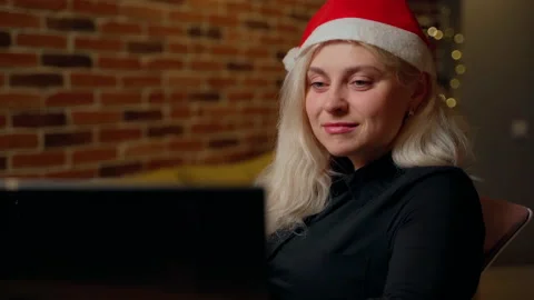 Woman resting at computer looking at screen drink water from cup at christmas Stock Footage 195293538