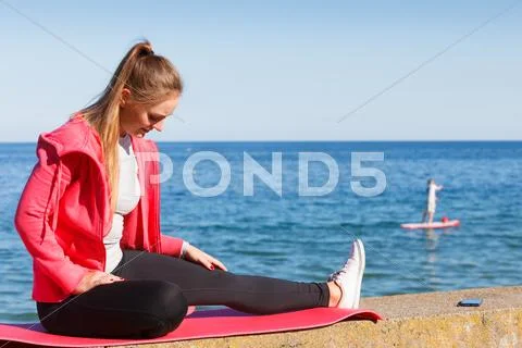 Woman resting relaxing after doing sports outdoors Stock Photos