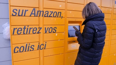 Woman retrieving parcel from Amazon locker Stock Footage 103412917