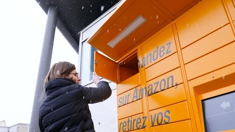 Woman retrieving parcel from Amazon locker Stock Footage 103413151