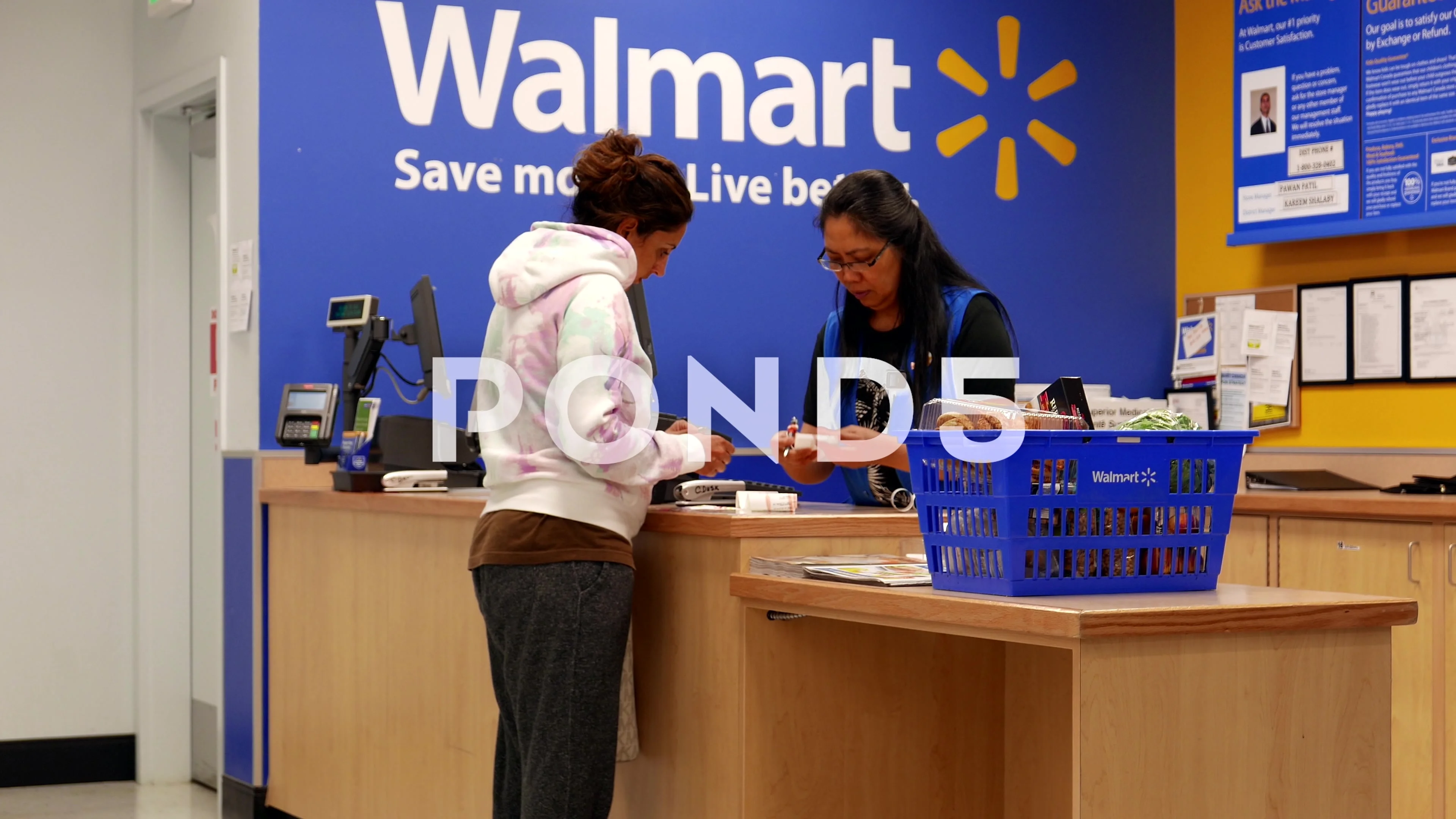 Woman Returning Goods At Customer Service Counter Inside Walmart