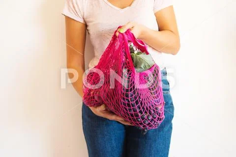Woman with reusable mesh bag full of produce Stock Photos