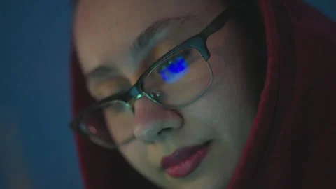 Woman Reviews Code In Calm Environment, Woman In Red Hoodie Working Intensely On Stock Footage 323932139