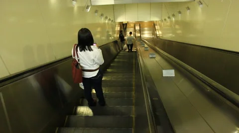 Woman Riding Down Escalator Stock-Footage 1085249