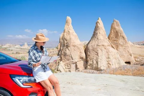 Woman road tripping and looking at the map. Travel by car Stock Photos